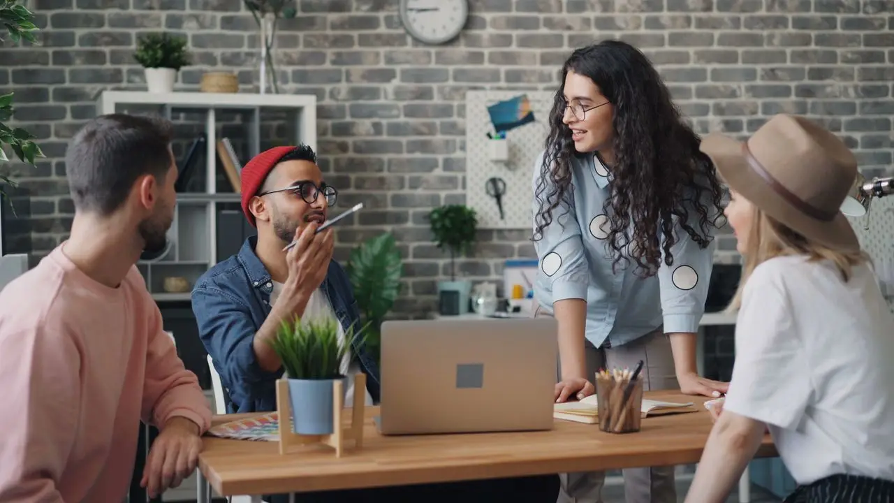 A diverse group of young professionals discussing a project in a stylish office setting