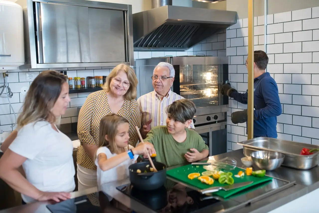 Multi-generational family preparing a meal together in a contemporary kitchen setting