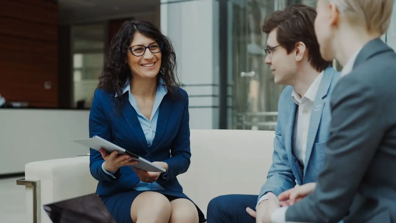 Professionals discussing business strategy in a corporate office setting